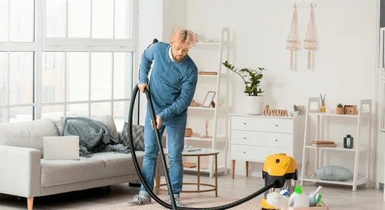 young-man-hoovering-carpet-home 3